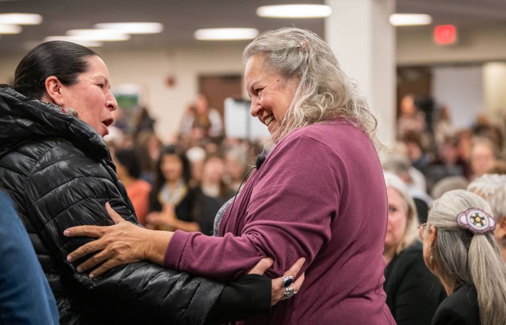 Robin Wall Kimmerer embraces Shannon Martin, one of the many Native American community members who traveled from near and far to see Robin speak.